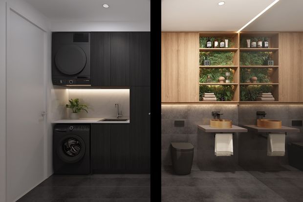 A split interior view showing a compact dark-toned laundry on the left, with stacked washer and dryer, integrated black cabinetry, a small sink and illuminated benchtop, alongside a contemporary bathroom on the right with twin vessel basins, wall-mounted taps, timber vanity cabinetry, open shelving with greenery, and dark grey wall and floor finishes.
