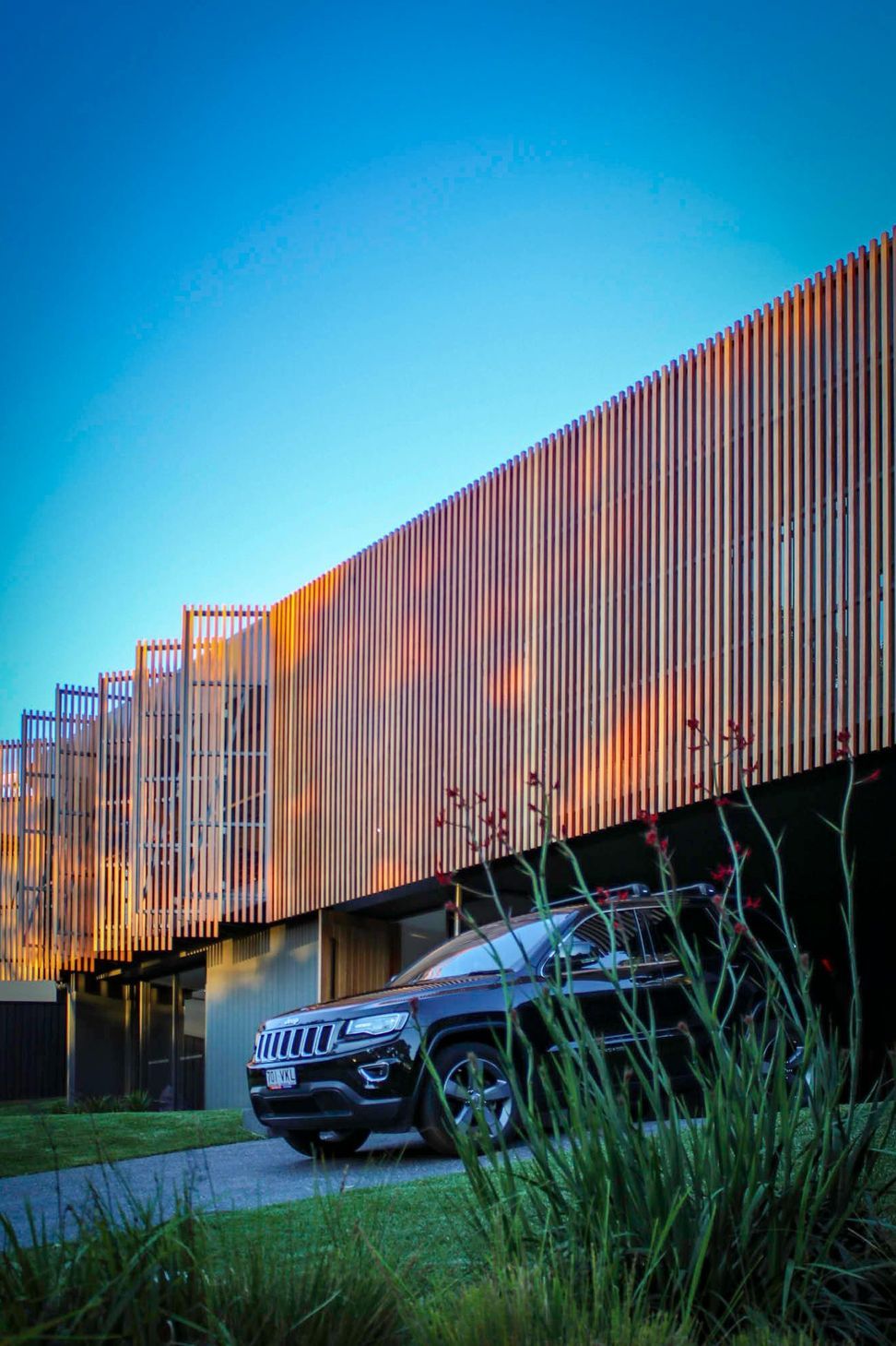 Glennon Residence - Exterior. Timber battens catching the late afternoon sun.