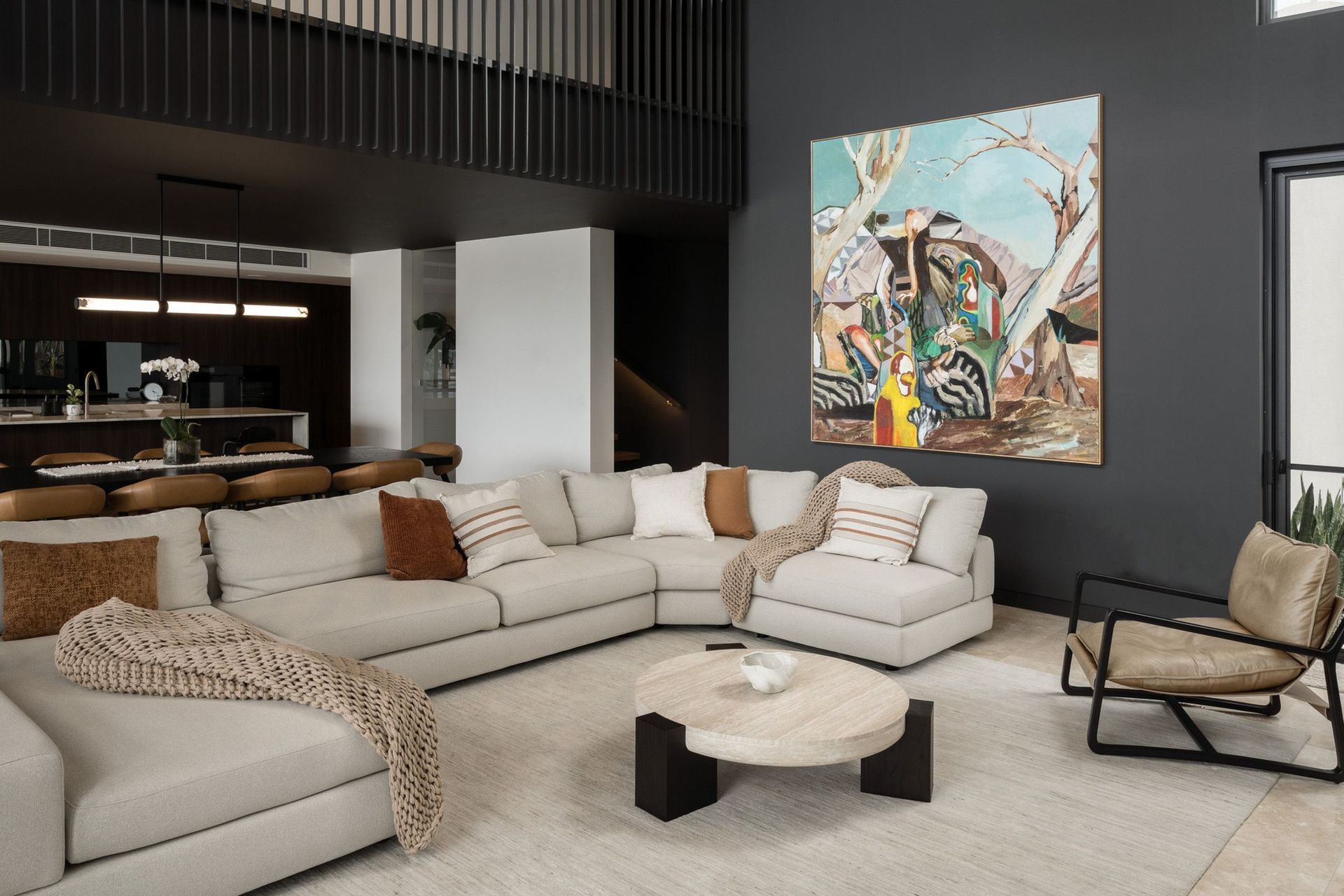 Carwoola House - Living Room. Open living area with layered seating and a feature artwork.