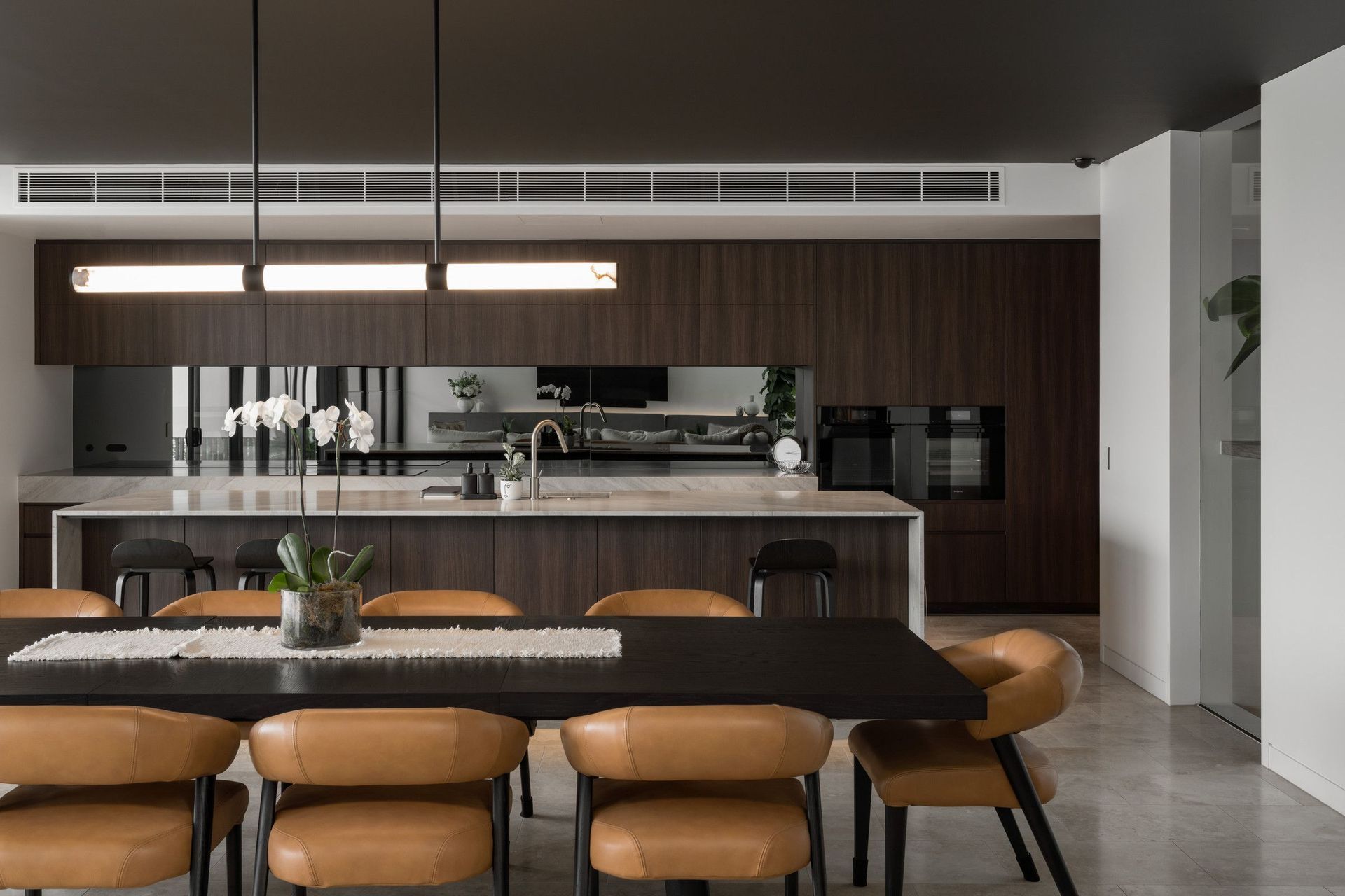 Carwoola House - Kitchen. Kitchen with a long island and leather dining chairs.
