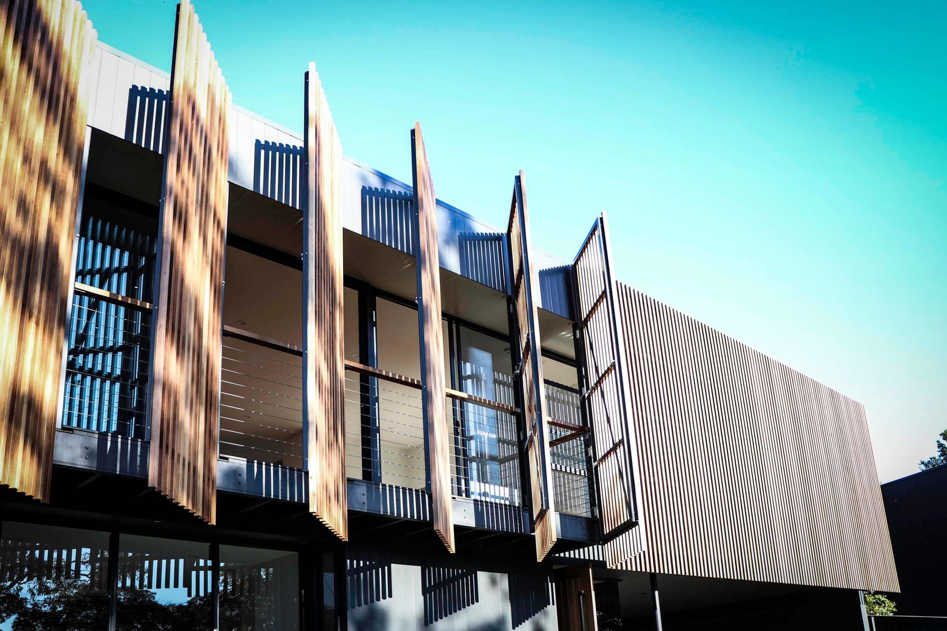 Glennon Residence - Exterior. Operable timber screens along the upper balcony.
