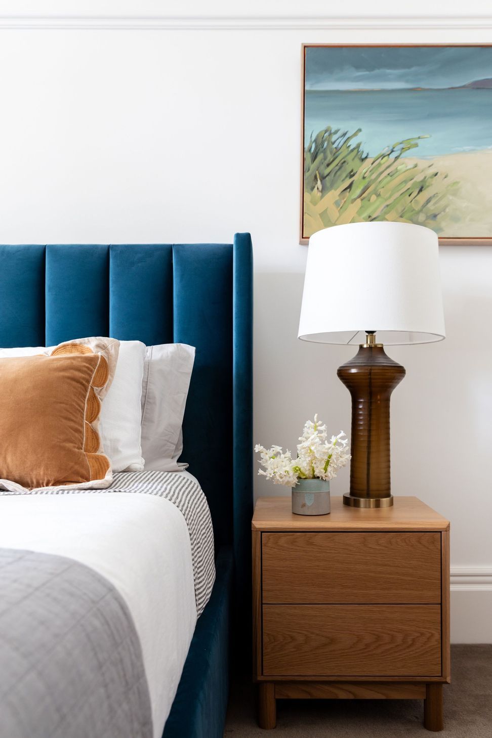 Bedroom-detail-with-velvet-bedhead-and-amber-lamp.jpg