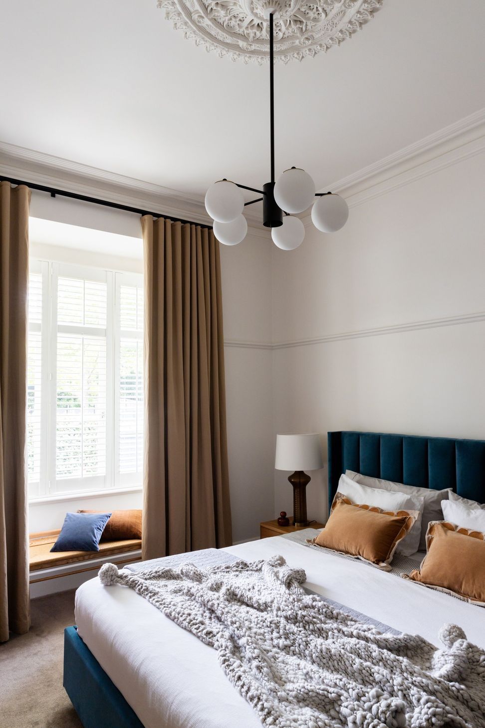 Bedroom-with-ceiling-rose-modern-pendant-and-tall-curtains-velvet-blue-bed.jpg