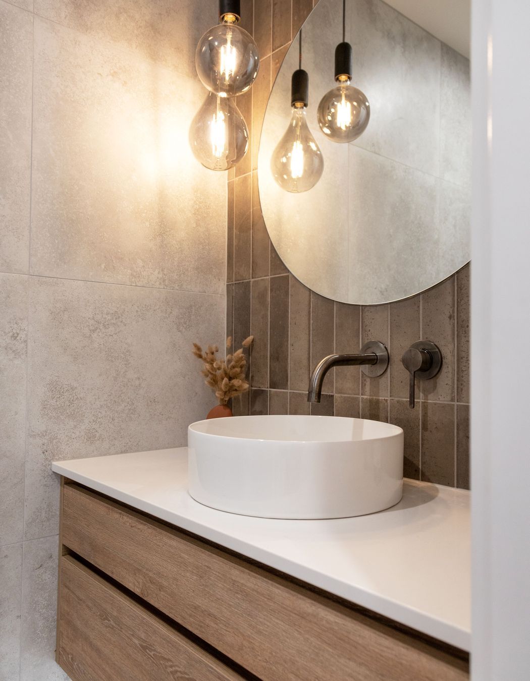 Modern bathroom. Feature lighting with round mirror. Photographer - Sandra Henderson