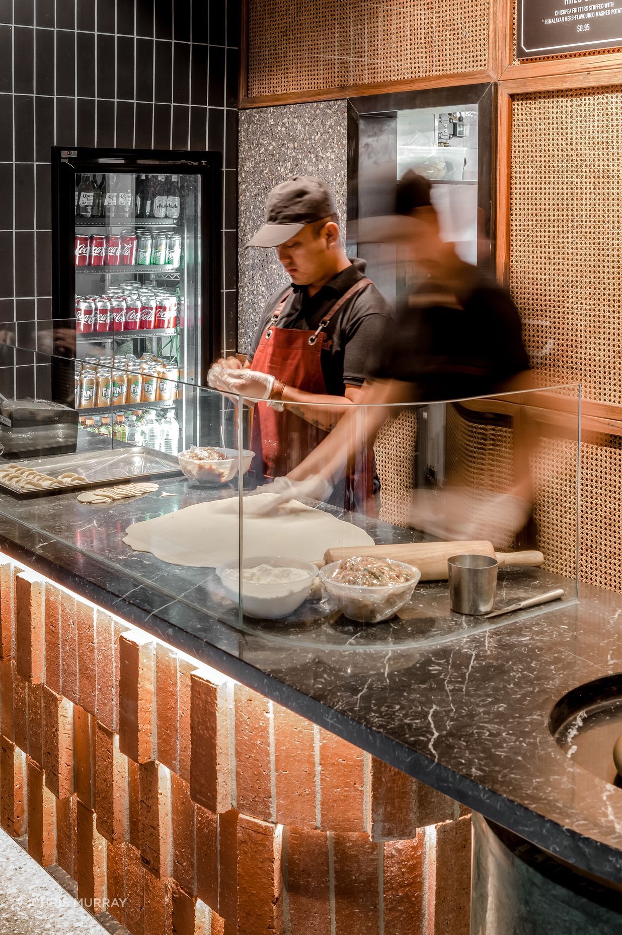 The service counter's layered effect using Rustic Red brick tiles and custom cut bricks