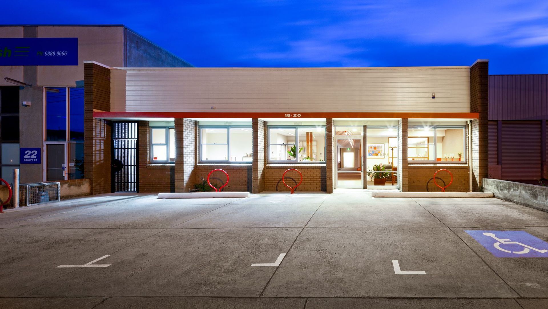 External view of 70’s single level office. Much of the outside remains – just the red bicycle racks signify the extensive internal renovations.