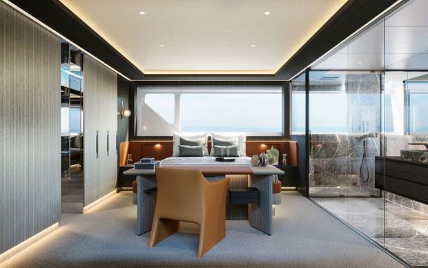 A refined contemporary interior combining a dining/work table, built-in upholstered bench seating, extensive dark-framed glazing, and integrated cabinetry. The room has a soft neutral palette, concealed linear lighting, and a glass-enclosed bathroom or wet area visible on the right.