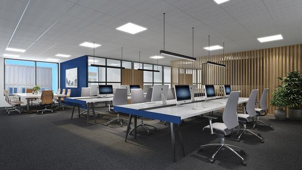A bright contemporary open-plan office with rows of white workstations, computer monitors, ergonomic task chairs, meeting tables, and a small meeting area by the windows. Black-framed glass partitions, a blue feature wall, vertical timber screening, suspended linear lights, and dark carpet define the commercial workspace.