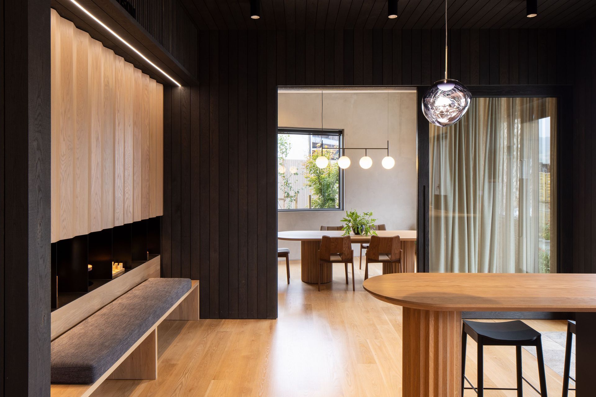 “We were quite careful about furniture that was selected, to complement the custom designed pieces and the oak panelling.” The curtain fabric is James Dunlop and the Tom Dixon Melt pendant is from ECC.