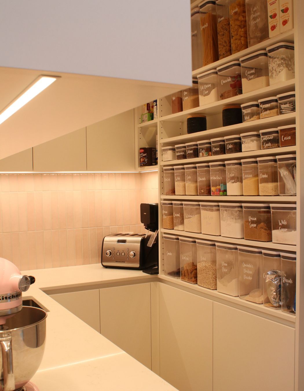 White V groove, black island and a scullery with a touch of pink