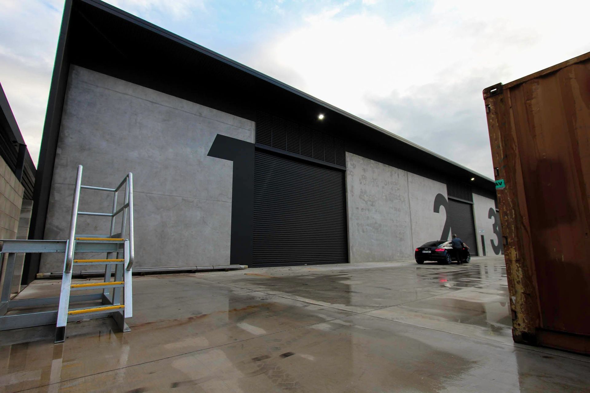 Eniquest Warehouse - Exterior. Concrete tenancy facade and loading area.