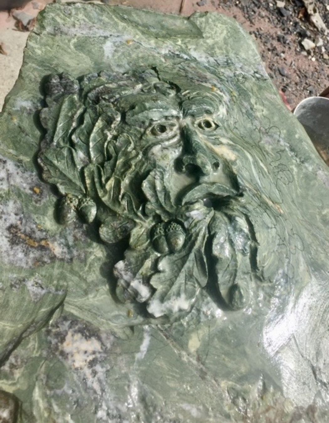 Carved Green man in green schist by Paul Gautron