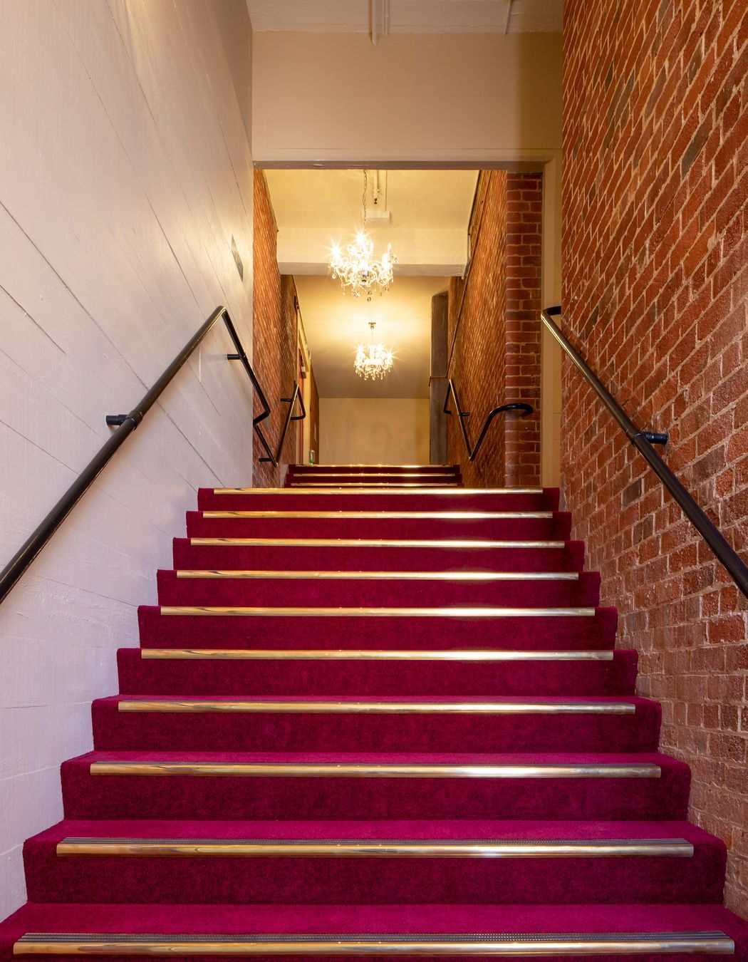 In ancillary spaces such as the stairwells, the new concrete shear walls have been left with the imprint of the rough sawn boards that were used as formwork as a reference to original finishes.