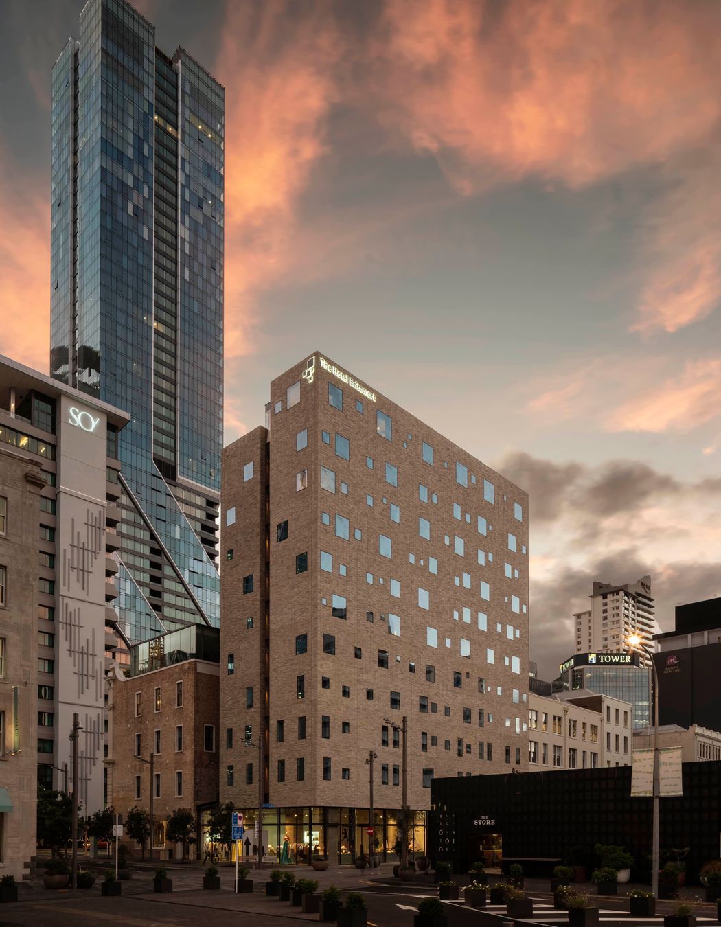 The Hotel Britomart's full brick facade is floating on a glass podium.