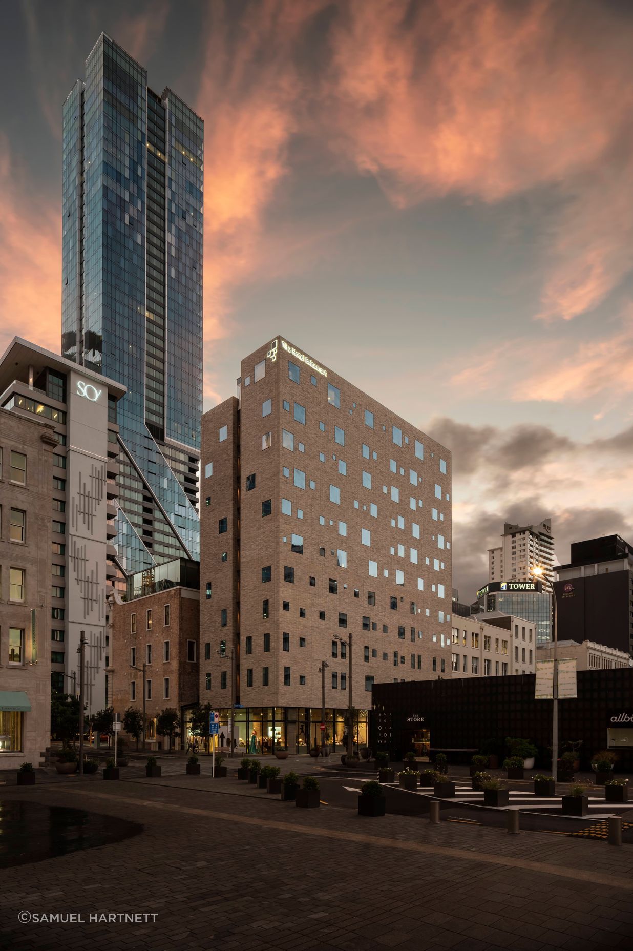 The Hotel Britomart's full brick facade is floating on a glass podium.  Image: Sam Hartnett