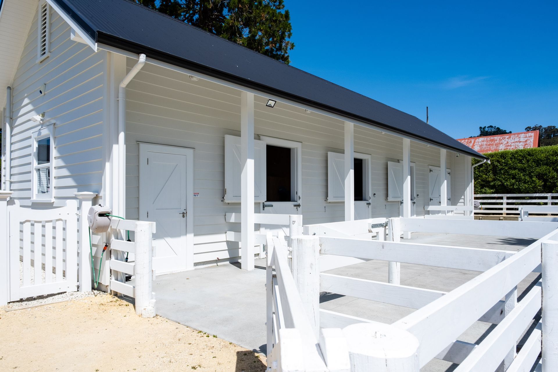Bespoke gates and beautiful painted fencing for stable yard.