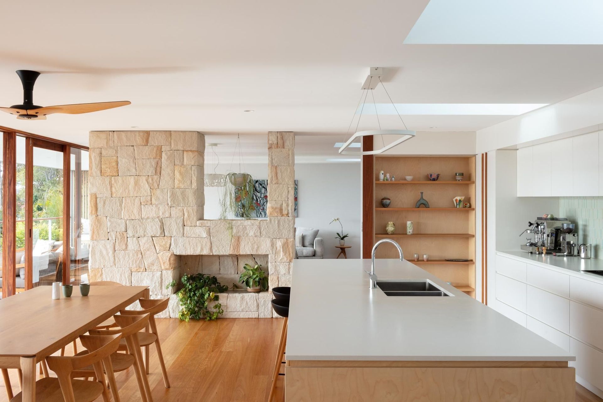 09-Matt-Day-Architect-Matt-Day-Bayview-House-Kitchen-Dining-Sandstone-Wall-Timber-Floor-Timber-Doors.jpg
