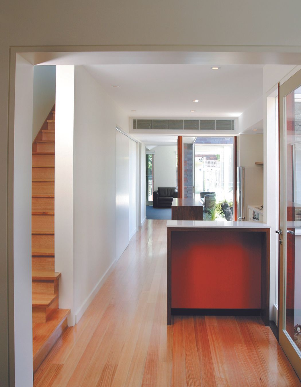 Modern timber kitchen bench and view of integrated courtyard