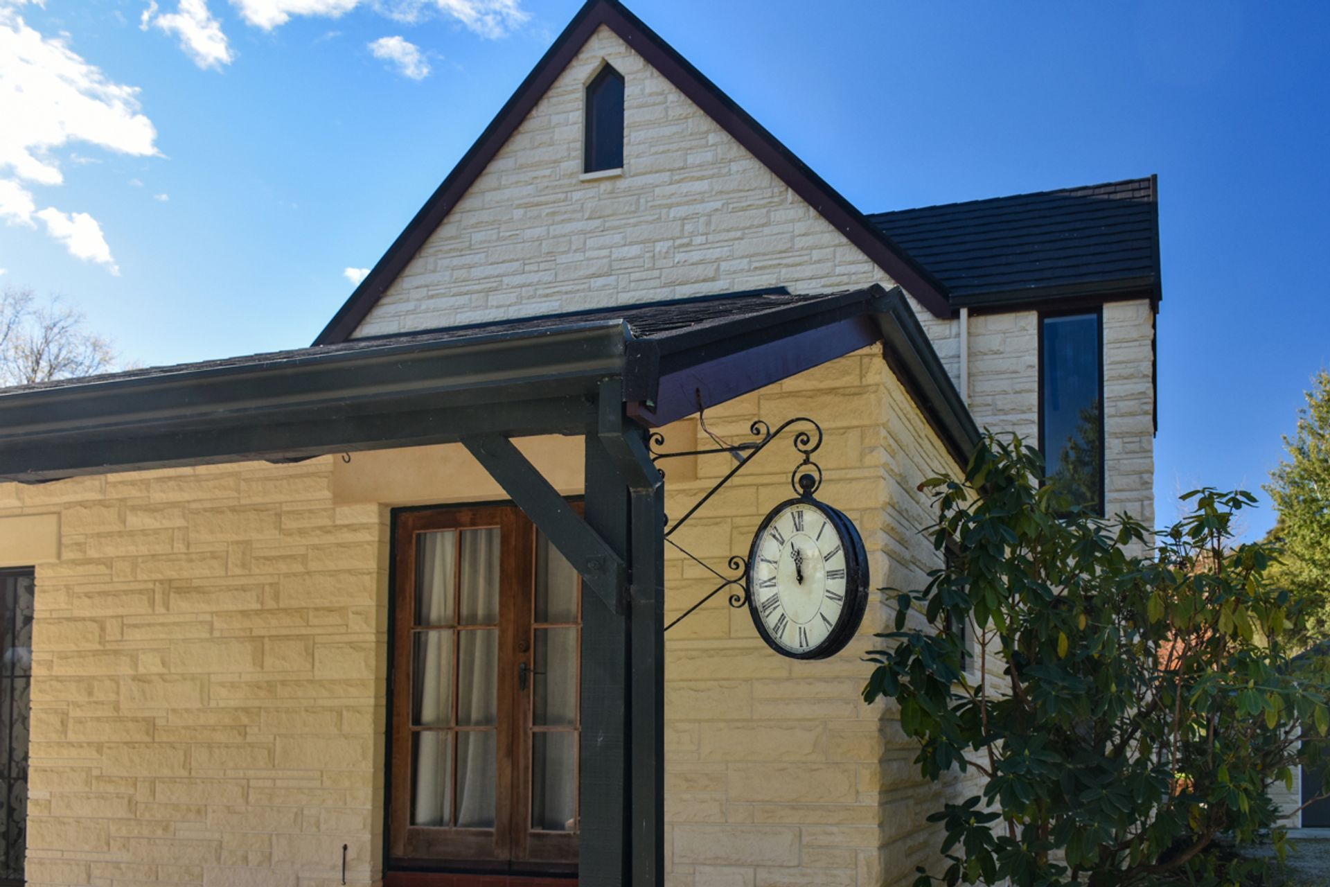 Close up of restored/cleaned stonework, new bargeboards and roofing - slate alternative