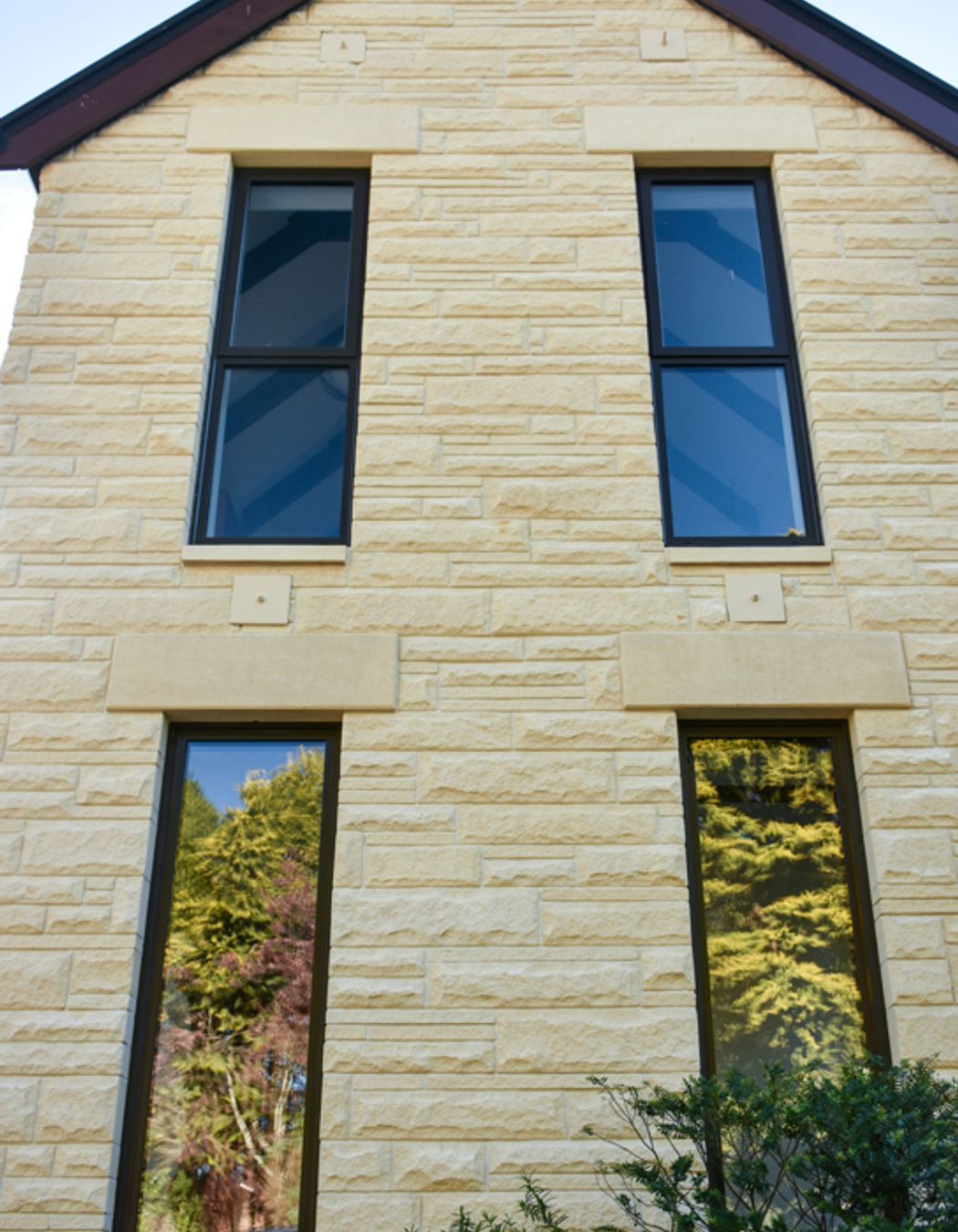 Close up of new double-glazed windows, bargeboards and cleaned/restored Oamaru stone from the courtyard
