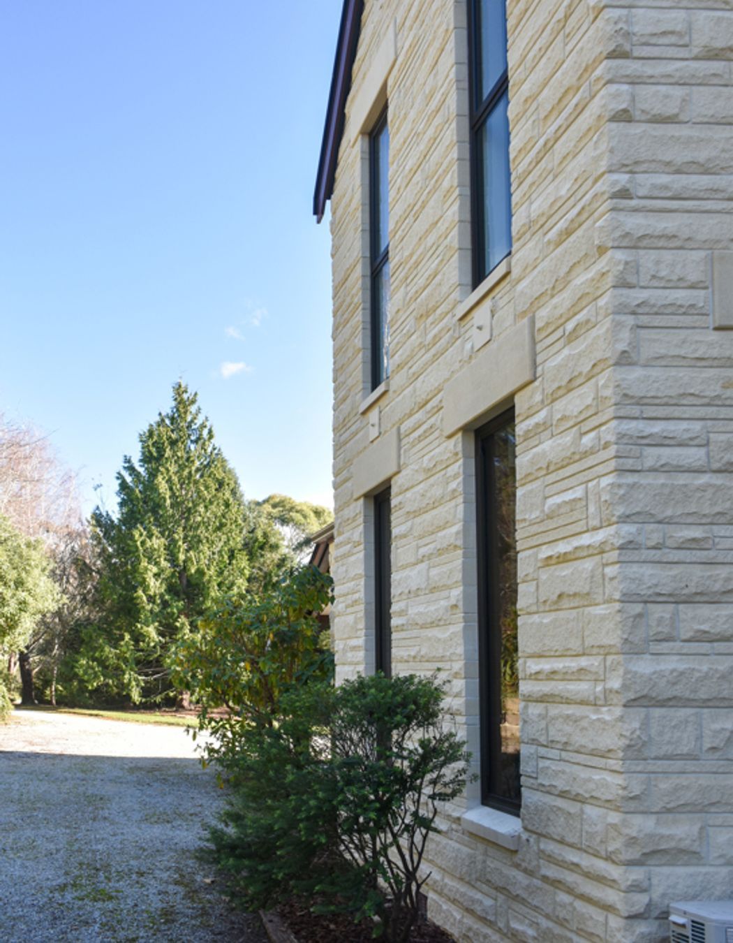 View from the courtyard showing new double-glazed windows, bargeboards and cleaned/restored Oamaru stone looking towards the sublime meandering driveway