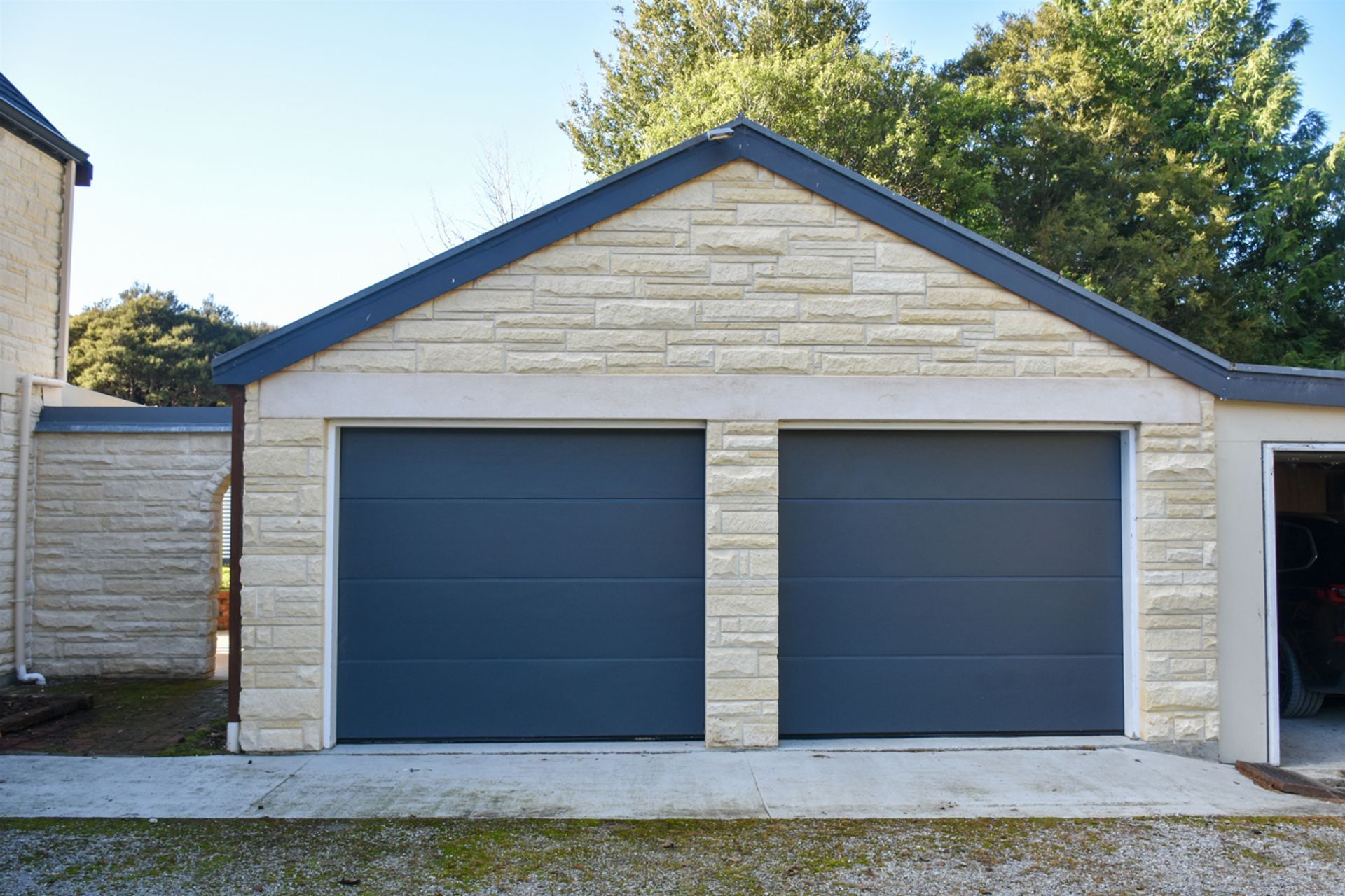 View of the garage with cleaned/restored Oamaru stonework.