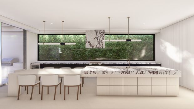 A bright, refined contemporary kitchen and dining space with a long white island, integrated cabinetry, four light timber dining chairs, and a dramatic veined stone benchtop. A matching stone rangehood feature hangs above the island, while slim linear pendant lights and a full-width window overlooking greenery create a calm, open atmosphere. Vertical wall panelling and minimal detailing reinforce the clean modern design.