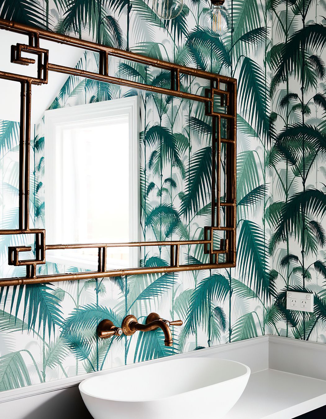 BAMBOO FRAMED MIRROR - This bamboo framed mirror had to be specially hung due to its great weight.  A fantastic hint of British colonial style in this powder room.