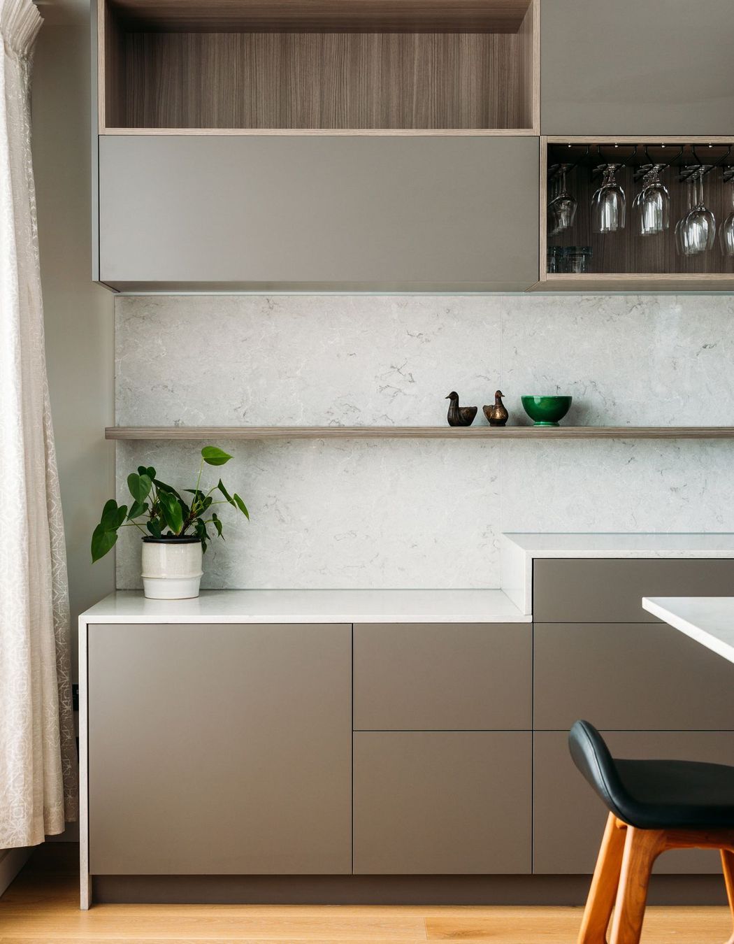 A storage zone where work-from-home equipment can be stored while cooking.