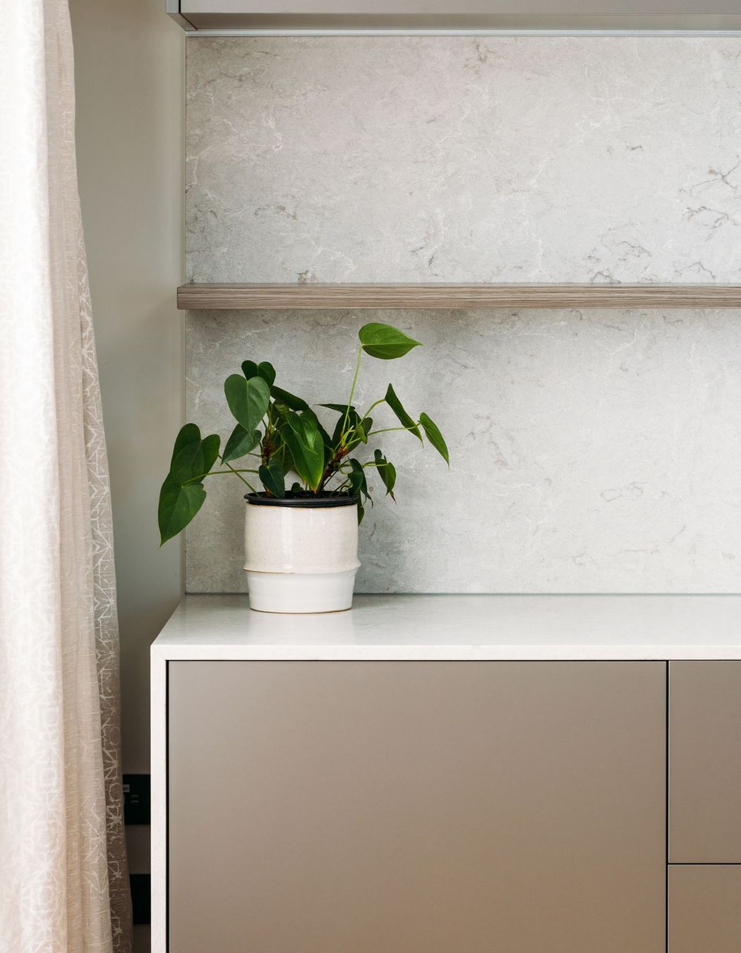 Melteca 'Iron Ore' Pearl and Ceasarstone Bianco Drift waterfall benchtop.