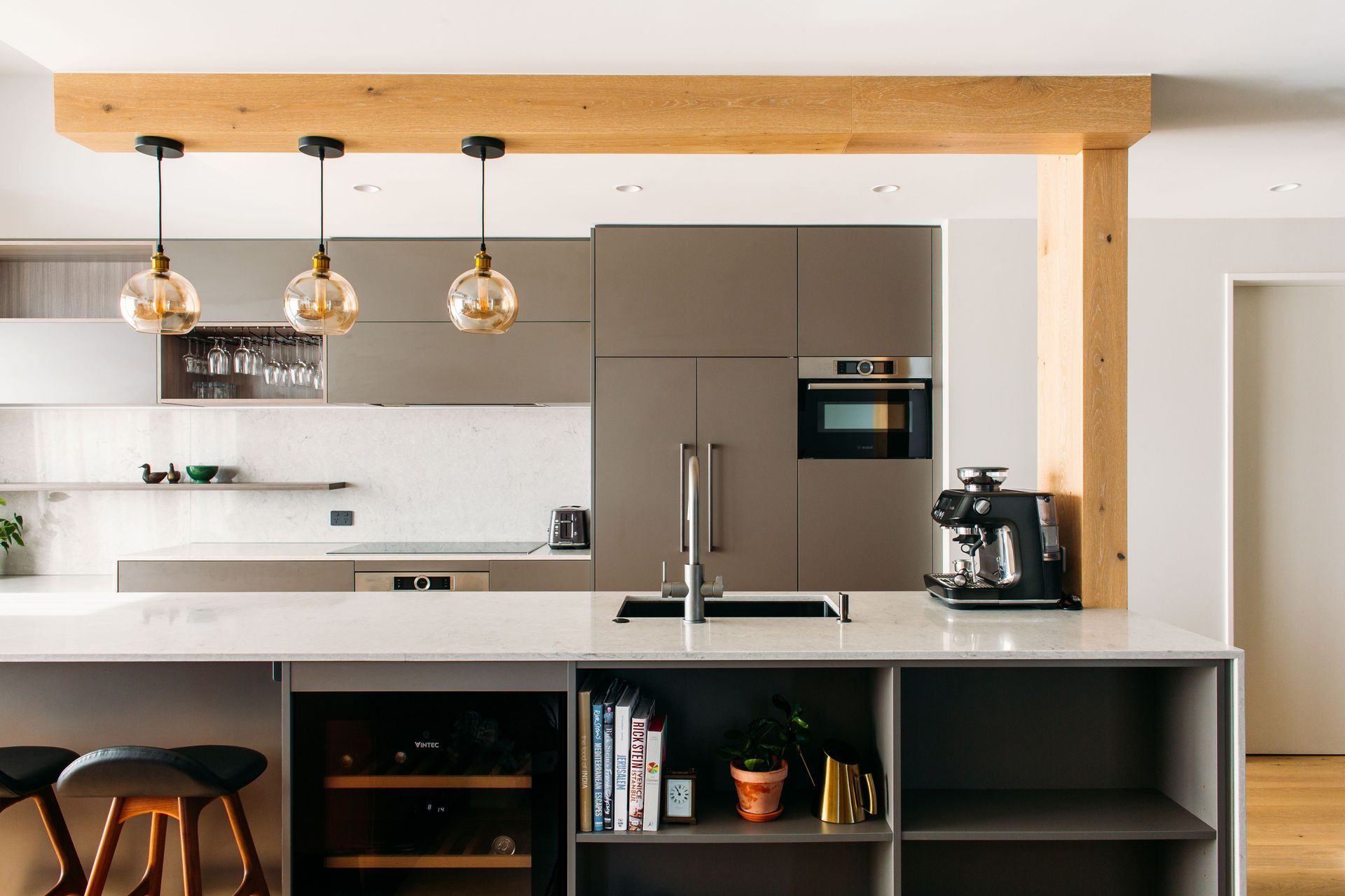 The ceiling feature arose through the need to accommodate the existing power and water services to the island bench.