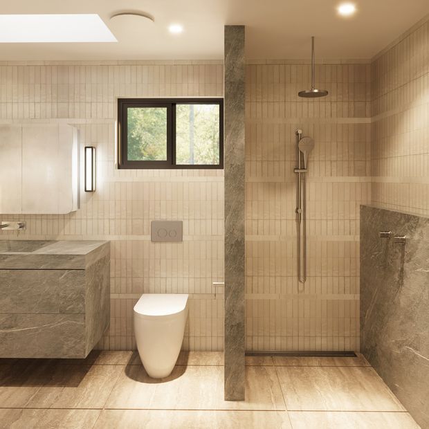 Warm contemporary bathroom with a walk-in shower, wall-hung toilet, floating stone vanity, vertical beige tiled walls, large-format stone-look floor tiles, and a dark-framed window. A central stone-clad partition separates the vanity and toilet area from the shower. Recessed ceiling lighting and a skylight provide soft illumination.