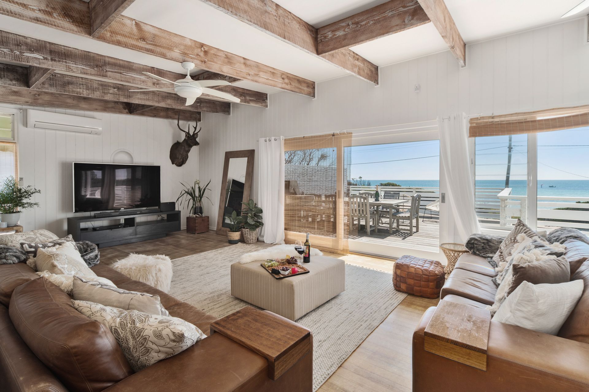 Indulge in coastal bliss at Fishermans' Cottage. Admire breathtaking views from the elegant living room overlooking Fishermans' Beach.