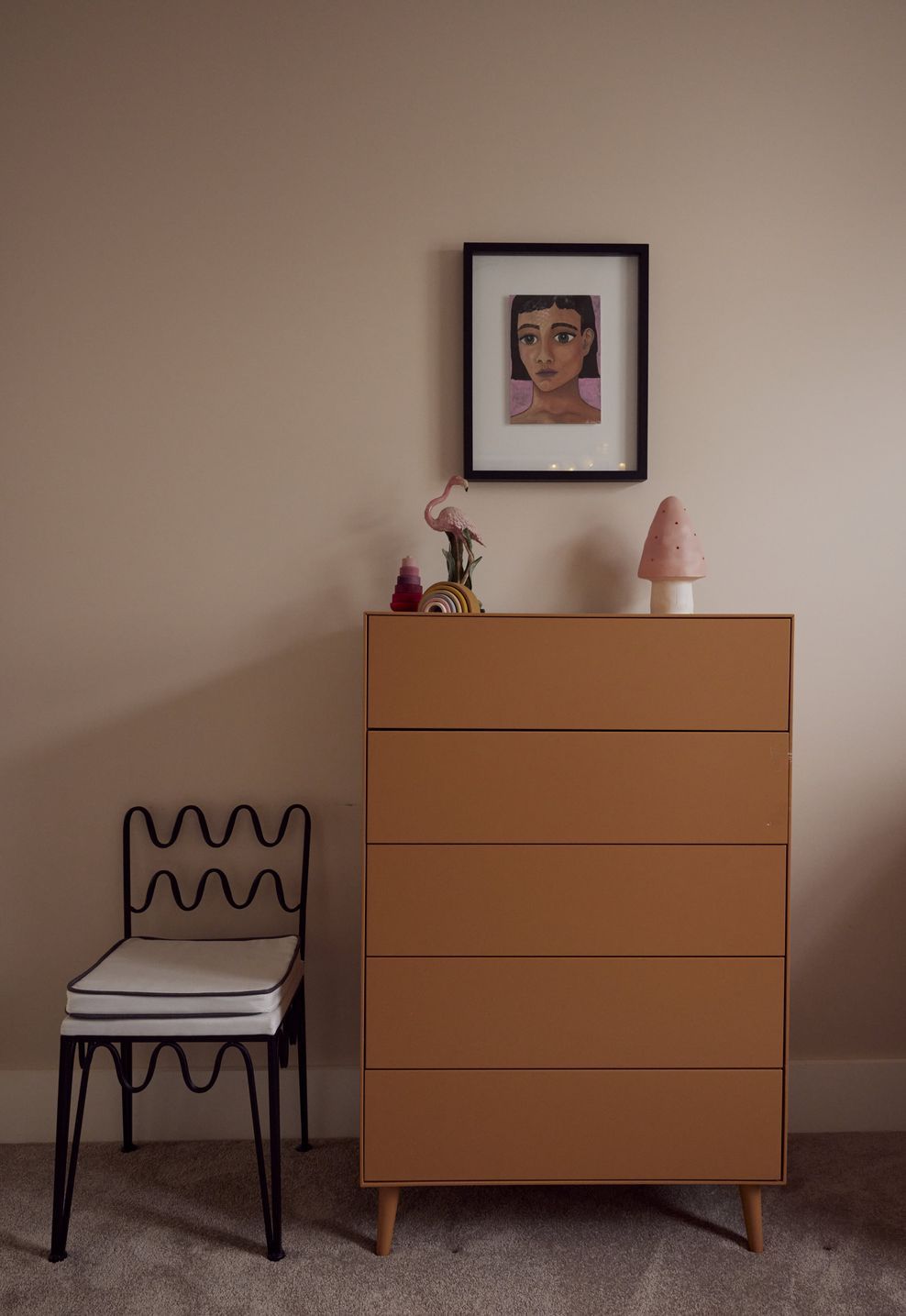 Terracotta tallboy, Rachel Donath wire chair and a framed portrait — playful and considered in equal measure. Point Chevalier Bungalow, in collaboration with Hannah Warren Interiors.