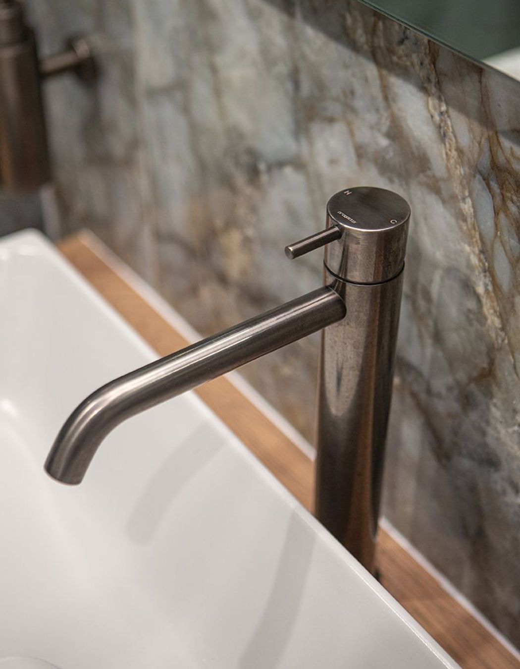 Aged iron basin mixer sits perfectly alongside the Patagonia tile.