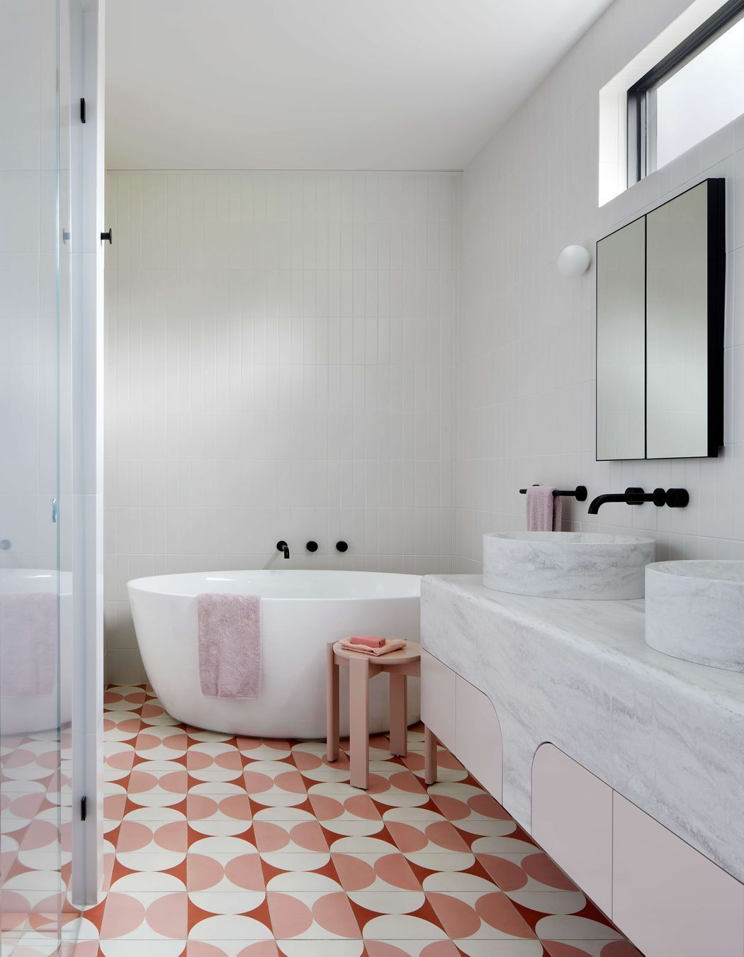 Art Deco inspired large ensuite bathroom with pink and cream Butterfly tile from Perini, featuring a top mounted, double sink from corian, Forme L'isola  Freestanding Bath  and walk in shower.   Located in Melbourne, see more from our Arch Deco Project. The colour scheme references the colours used commonly during the Art Deco period of the house.