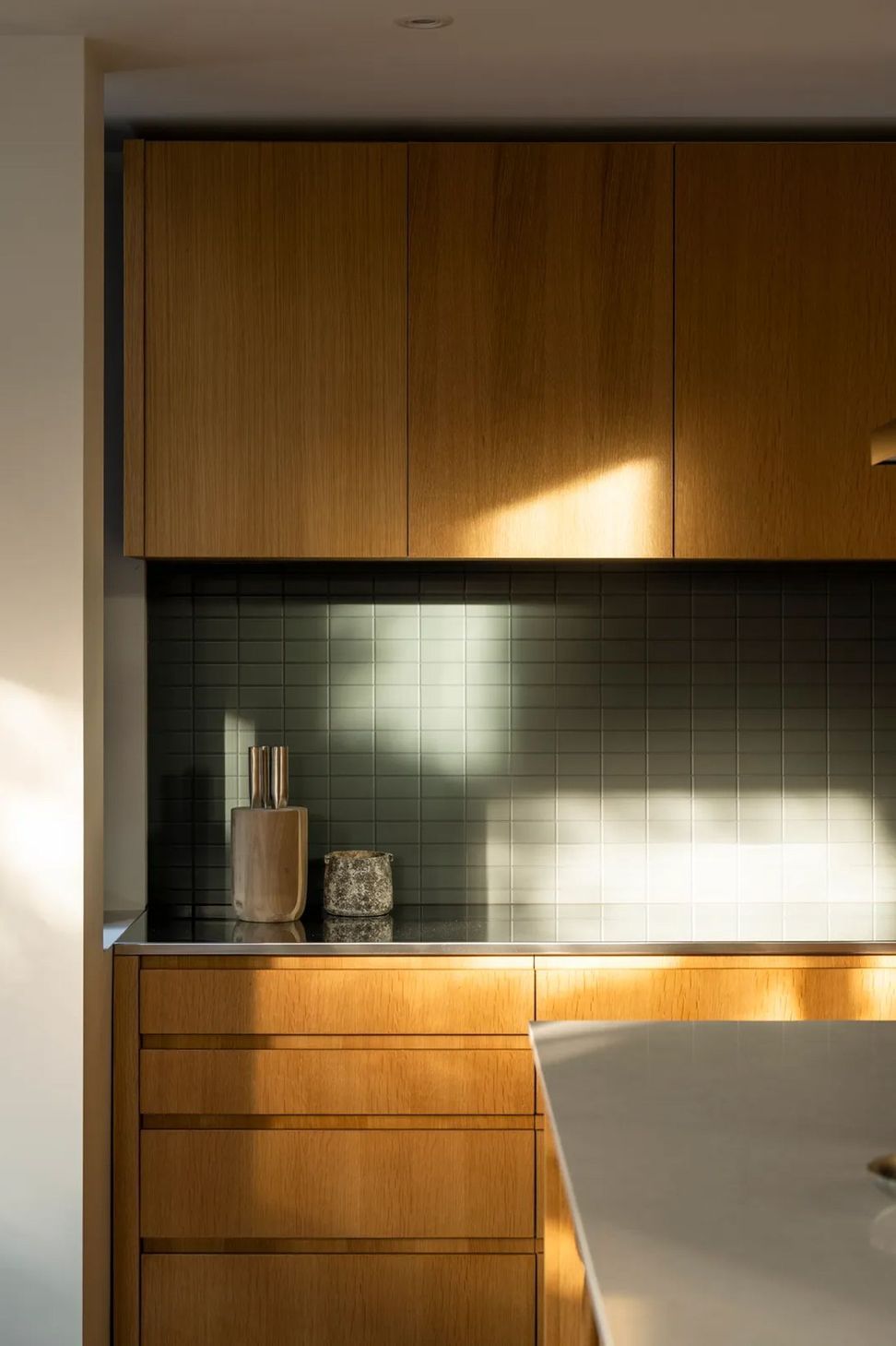 The kitchen receives morning and evening light and is the heart of the open-plan living area.