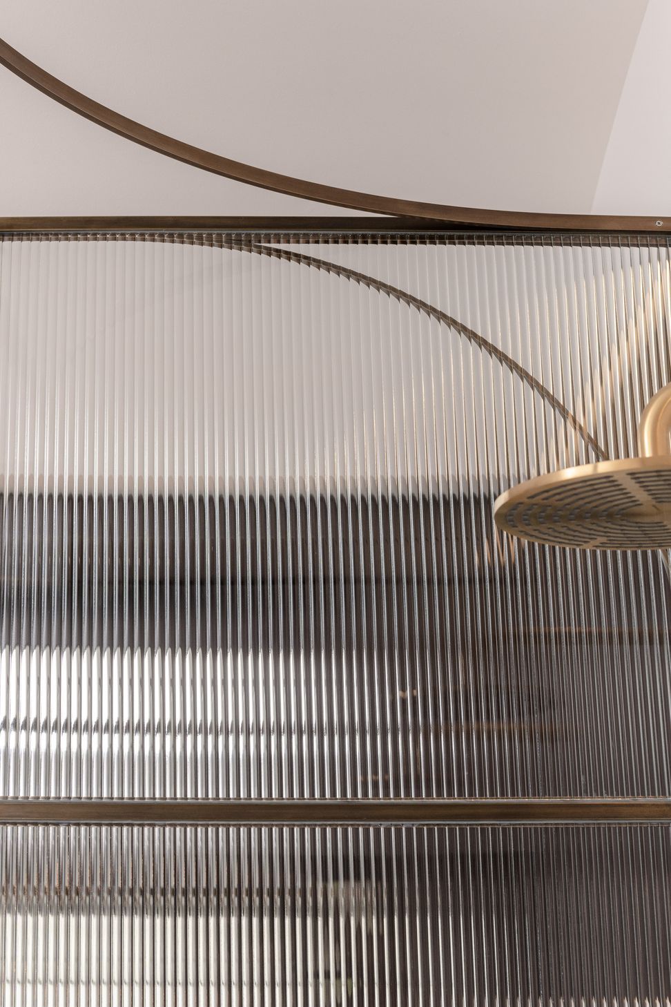 Curved brass and fluted glass details