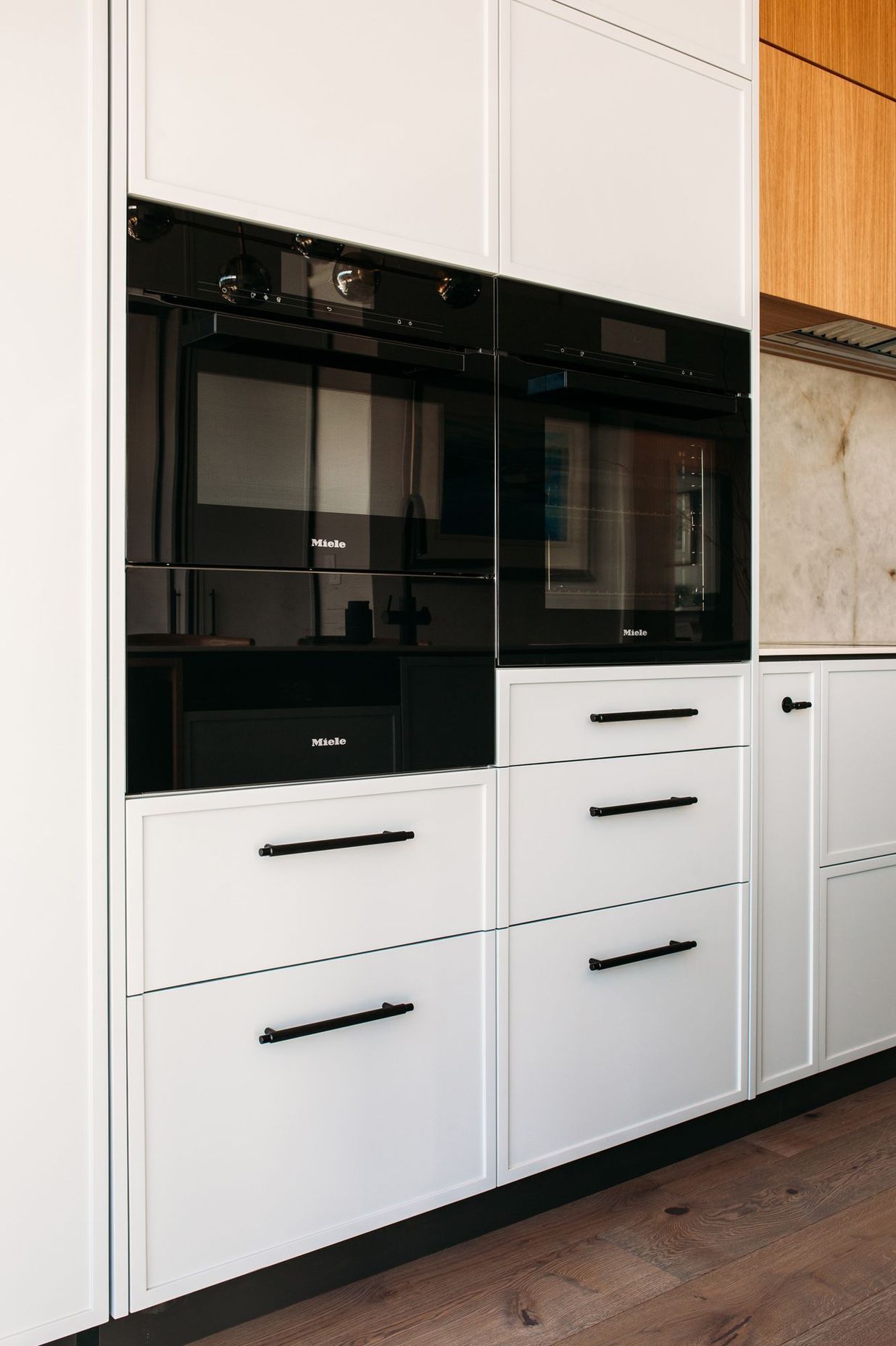 Careful planning of the kitchen cabinetry has resulted in a contemporary shaker style look.