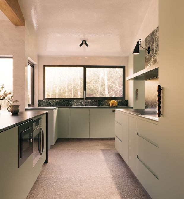 A compact contemporary galley kitchen with pale cabinetry, dark stone countertops and backsplash, integrated appliances, and a warm textured floor. Large black-framed windows bring in abundant natural light, while a sculptural timber ceiling beam, black wall sconces, and a dark rangehood add visual contrast.