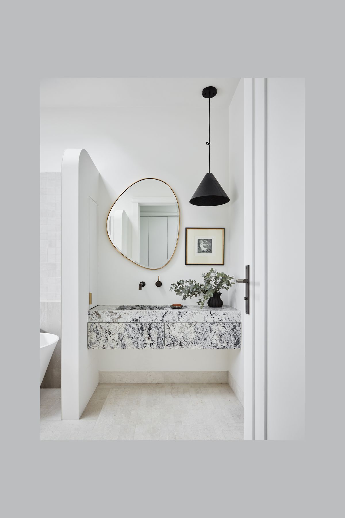 MAIN BATHROOM Summit 330 pendant light, About Space. Pebble mirror, Life Interiors. White granite vanity, Granite &amp; Marble Works. Brodware ‘City Stik’ wall mixer, Sydney Tap and Bathroomware. Limestone floor tiles, Onsite Supply+Design. Boost wall tiles, Rocks On.