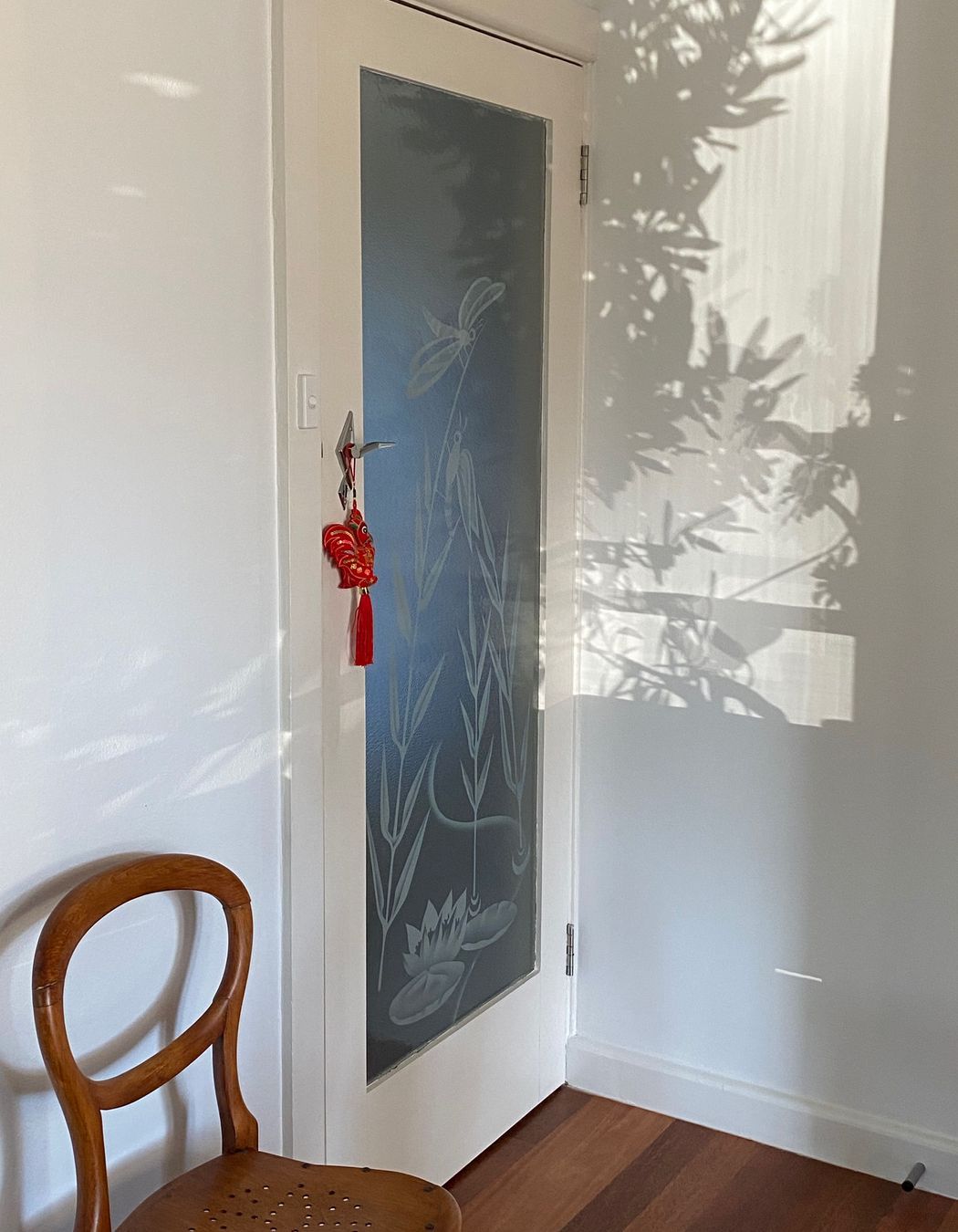 Biophilia at work: the etched glass doors and shadows from foliage put on a stunning light show