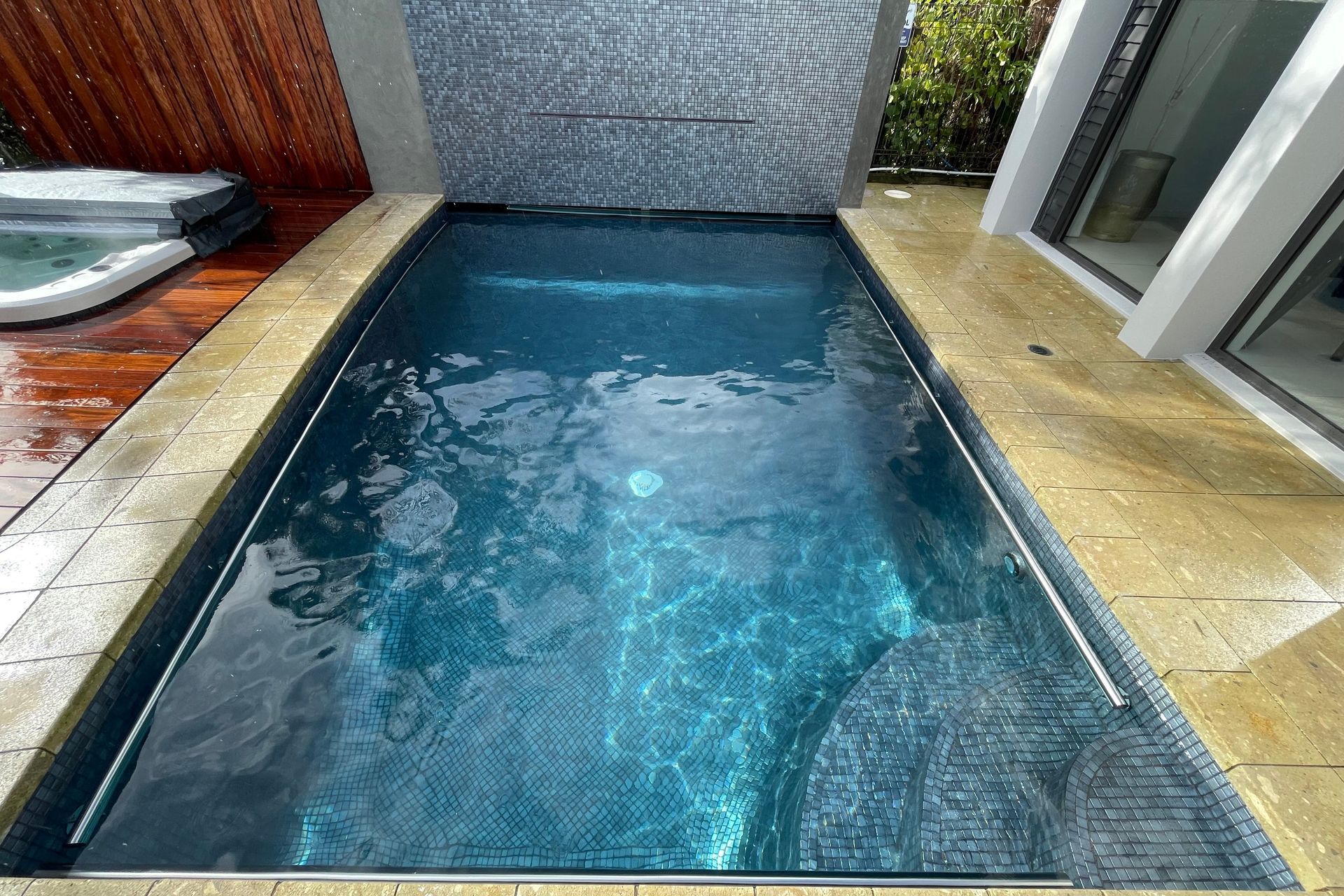 The old pool plaster was removed, and the option to fully tile with Ezarri Capricorn tiles was a very wise one!  It looks incredible, and is also very durable.