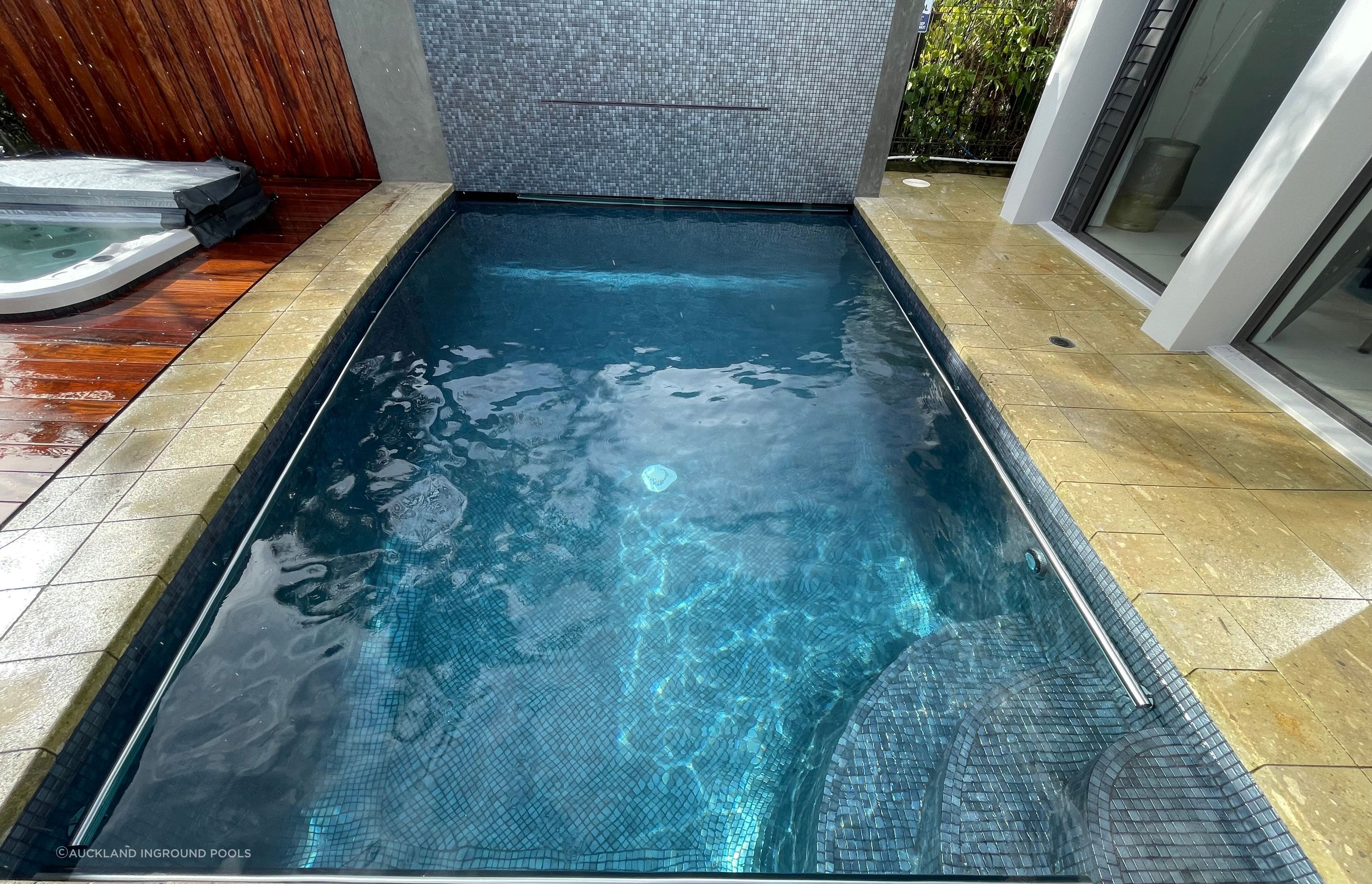 The old pool plaster was removed, and the option to fully tile with Ezarri Capricorn tiles was a very wise one!  It looks incredible, and is also very durable.