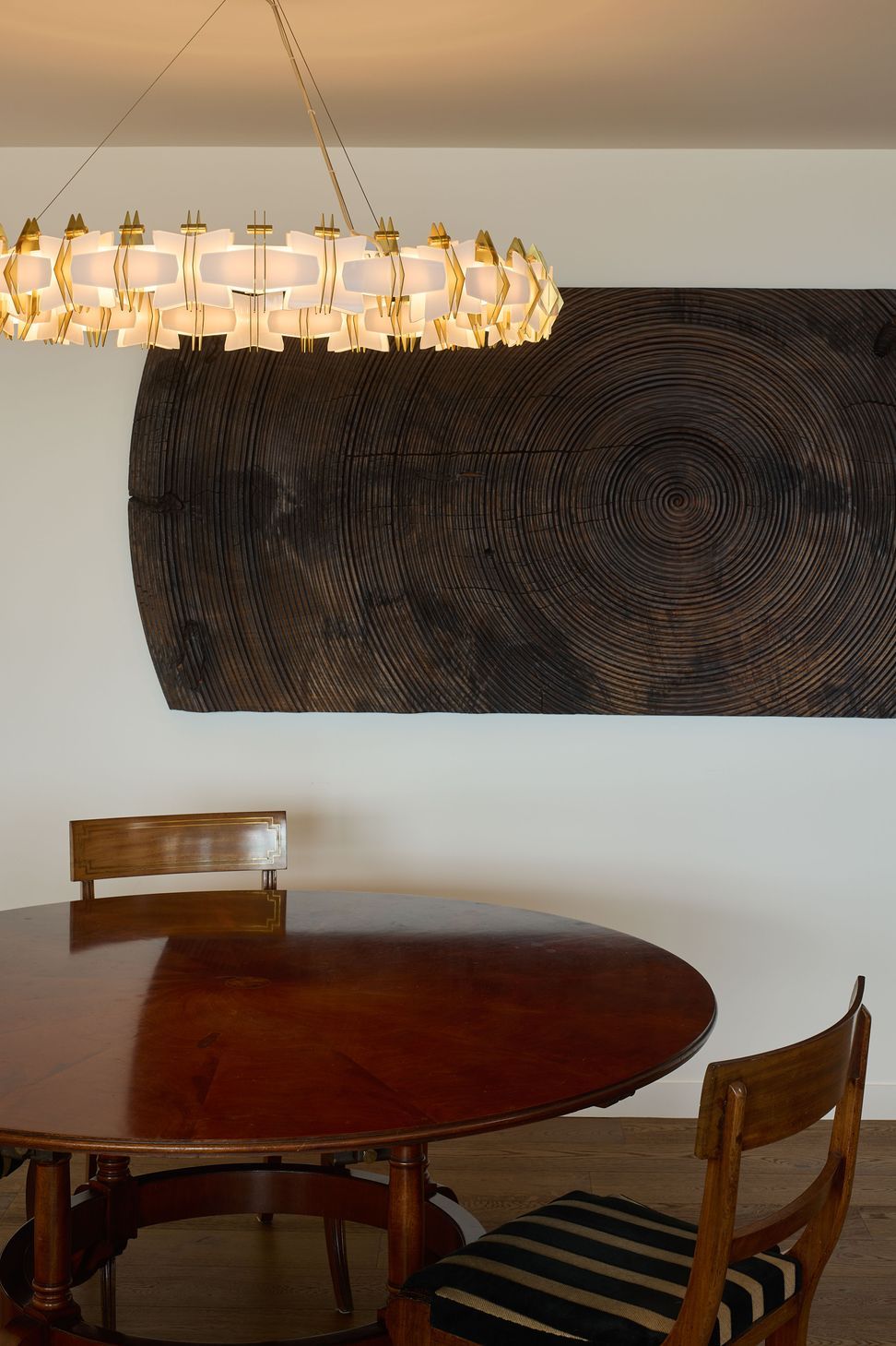 The dining area at The High Life showcases the clients' vintage artwork collection, integrated seamlessly into a refined interior by Rogan Nash Architects.
