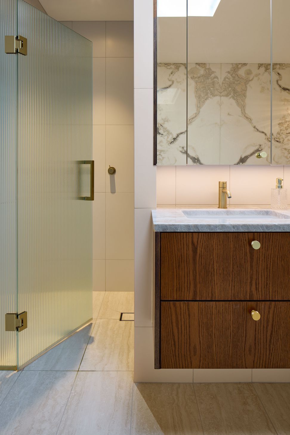 Classic fittings and understated elegance define the ensuite at The High Life, a Queen Street apartment refurbishment by Rogan Nash Architects.