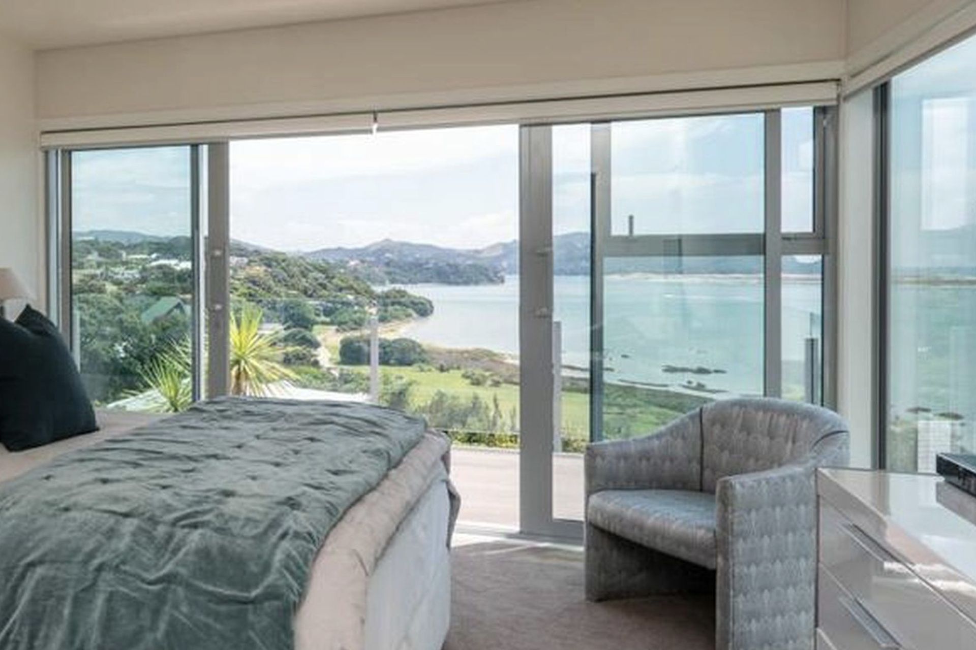 Bi-parting sliding doors lead from master bedroom to East facing deck