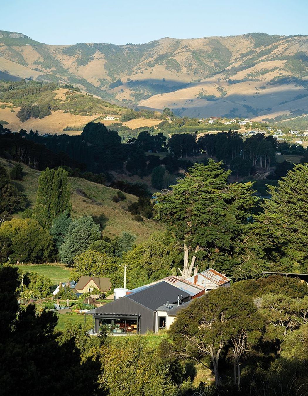 Nestled into Banks Peninsula, this three-bedroom family home was once a cow shed.