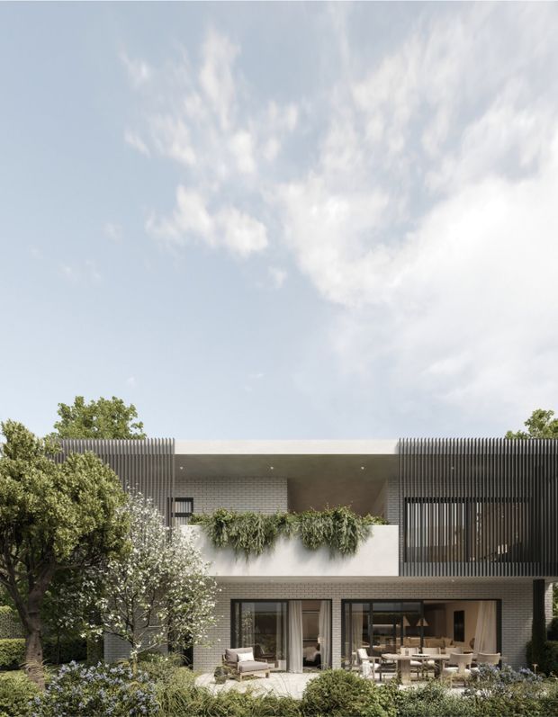Contemporary two-storey residential facade with a flat roof, light masonry cladding, extensive dark-framed glazing, and vertical slatted screens. The upper level includes a recessed terrace or balcony with planter greenery, while the ground floor opens to a landscaped garden and outdoor seating area. The composition is clean and modern, softened by dense planting and mature trees.