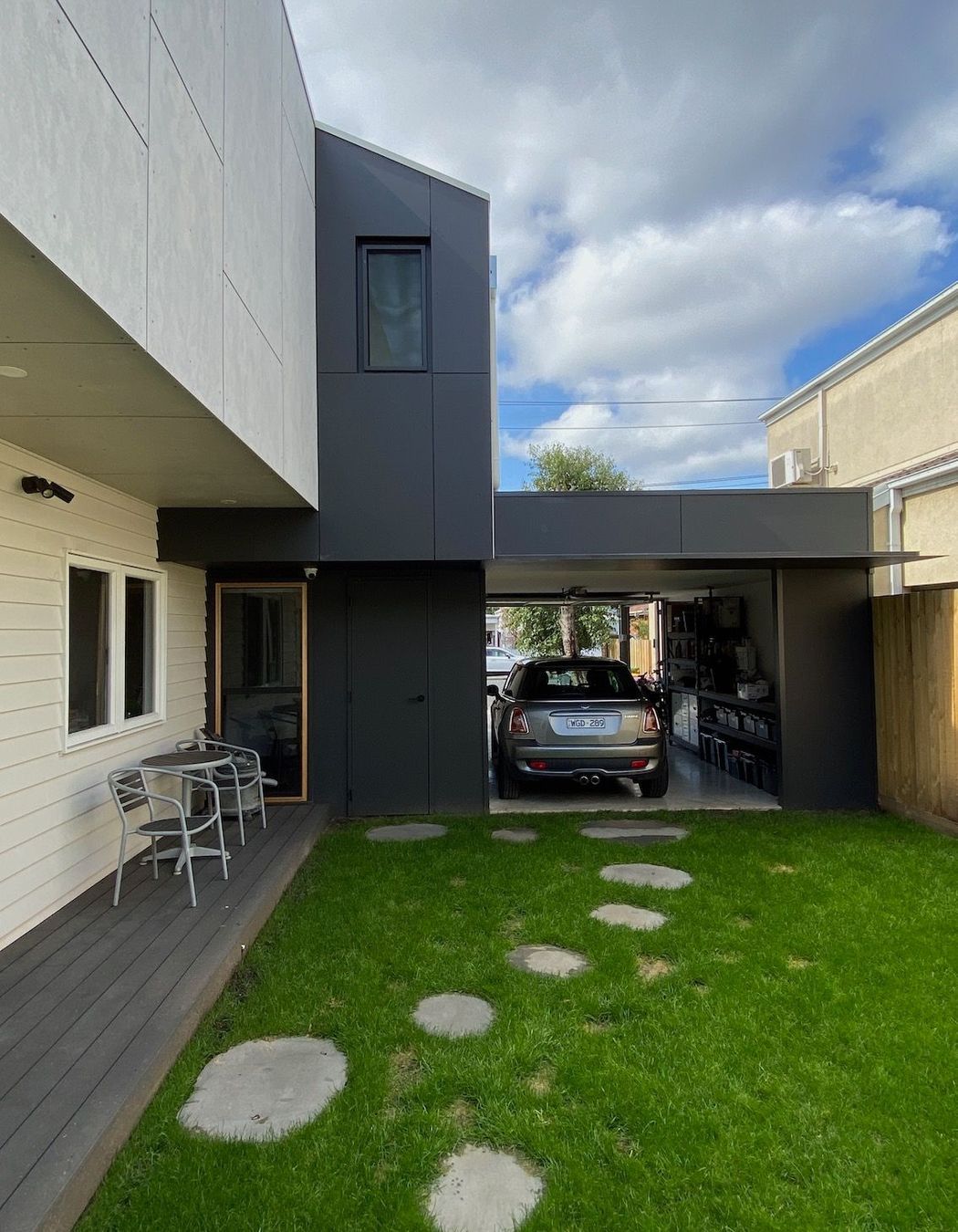 The garage provides privacy to the side garden and can be used as a space for entertaining